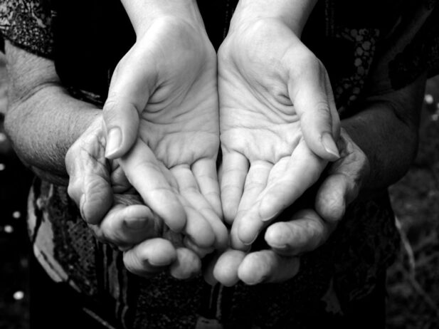 Young hands nestled in old hands.